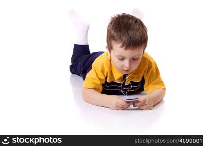 Cute little boy listening to music with earphones