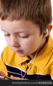 Cute little boy listening to music with earphones