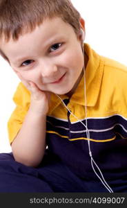 Cute little boy listening to music with earphones