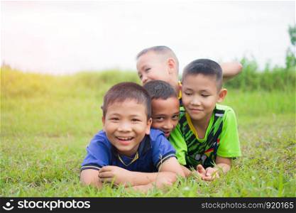 cute little boy lying on grass and feeling happy. soft focus.