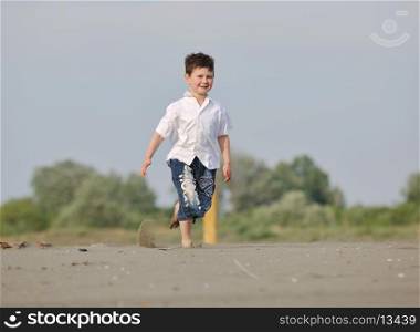 cute little boy running on beach and have fun