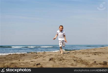cute little boy running on beach and have fun