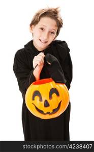 Cute little boy trick or treating on Halloween. Isolated on white.