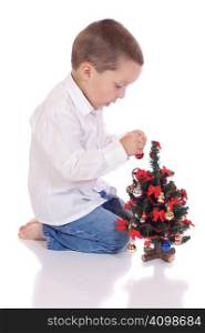 Cute little boy with a christmas tree