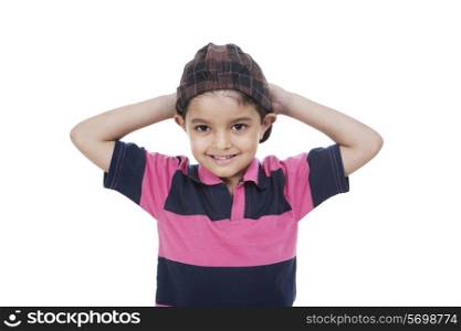 Cute little boy with hands behind head