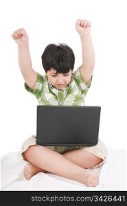 cute little boy with laptop in his bed on white