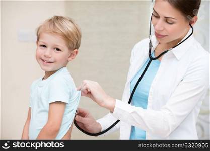 Cute little boy with pleasure visiting pediatrician, scheduled check up of babys health, appointment with the family doctor, healthy lifestyle