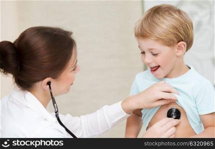Cute little boy with pleasure visiting pediatrician, scheduled checkup of a baby health, appointment with the family doctor, healthy lifestyle
