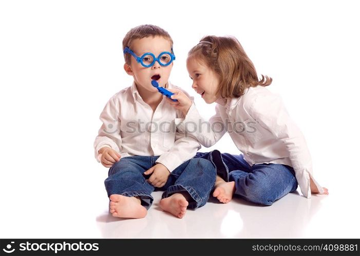 Cute little brother and sister playing doctor