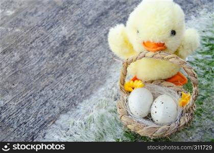 cute little chicken toy and basket with two easter eggs on the stone path - easter concept.. cute little chicken toy and basket with two easter eggs on the stone path - easter concept