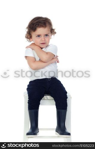 Cute little child with boots isolated on a white background