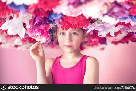 Cute little cutie among colorful flowers