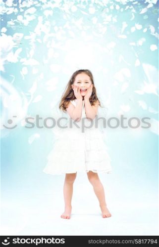 Cute little girl among flying rose petals