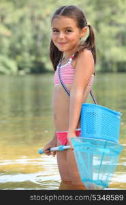 cute little girl fishing in river