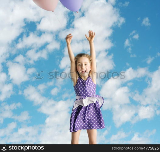 Cute little girl flying up to the sky