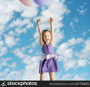 Cute little girl flying up to the sky