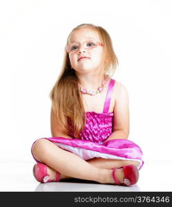 cute little girl glasses sitting on floor studio shot isolated on white background