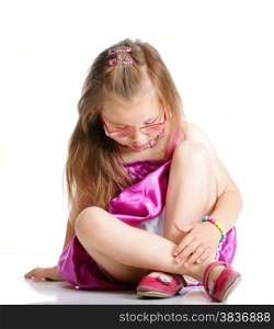 cute little girl glasses sitting on floor studio shot isolated on white background