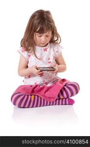 Cute little girl holding a portable video game
