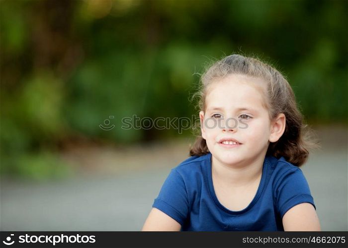 Cute little girl in a summer day with blue t-shirt