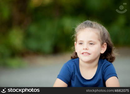 Cute little girl in a summer day with blue t-shirt