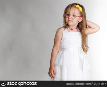 cute little girl in white dress glasses studio shot grey background
