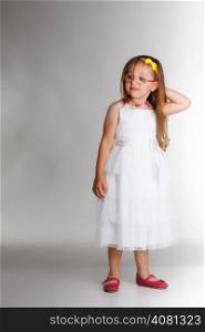 cute little girl in white dress glasses studio shot grey background