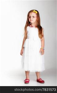 Cute little girl in white dress glasses studio shot grey background