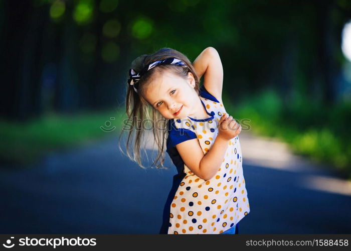 Cute little girl is having fun, jumping and laughing outdoors. happy childhood.. Cute little girl is having fun, jumping and laughing outdoors. happy childhood