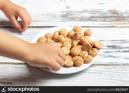 Cute little girl is playing with Santa's cookies and milk at Christmas