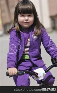 cute little girl learn to drive bicyle at sunny day