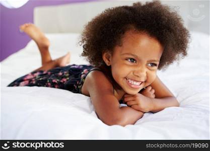 Cute Little Girl Lying On Tummy In Parent&#39;s Bed