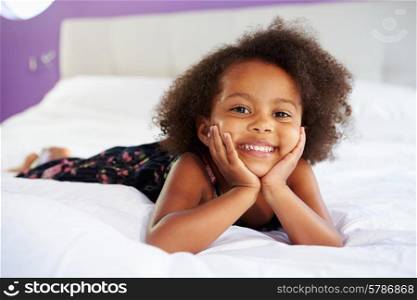 Cute Little Girl Lying On Tummy In Parent&#39;s Bed