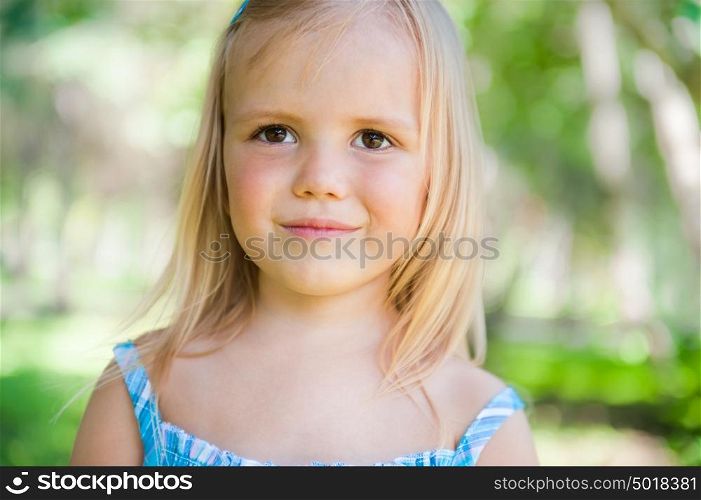 Cute little girl on the meadow in summer day