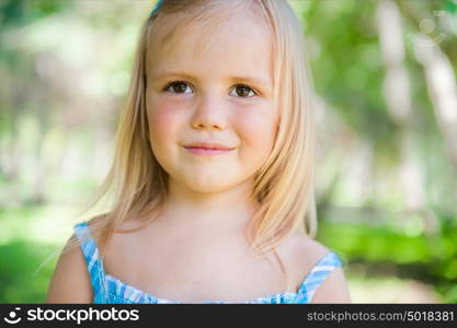 Cute little girl on the meadow in summer day