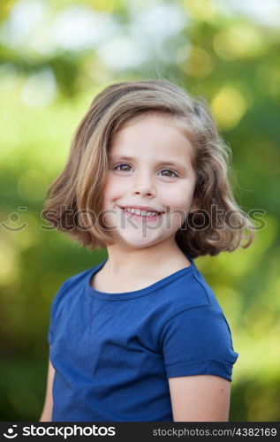 Cute little girl on the park in summer day