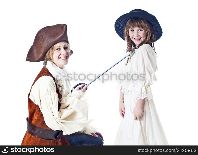 Cute little girl poses with her pretty aunt agaisnt a white background.