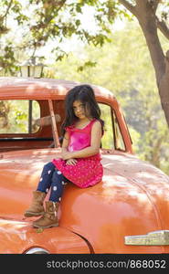 Cute little girl posing on a cargo truck