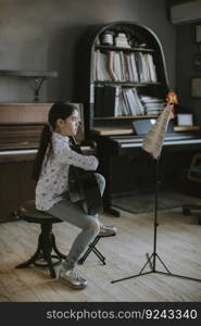 Cute little girl practicing on a acoustic guitar at rustic home