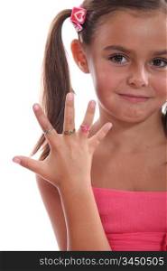 cute little girl showing the rings on her hand