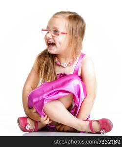 cute little girl sitting on floor and smiling, studio shot isolated on white background