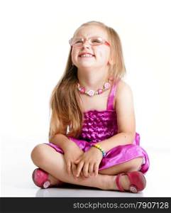 cute little girl sitting on floor and smiling, studio shot isolated on white background