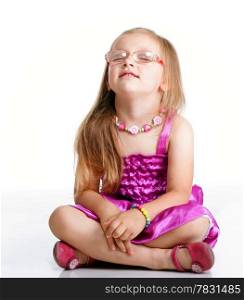 cute little girl sitting on floor dreaming with closed eyes studio shot isolated on white background