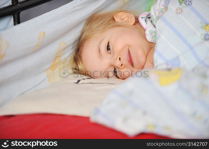 Cute little girl sleeping in bed