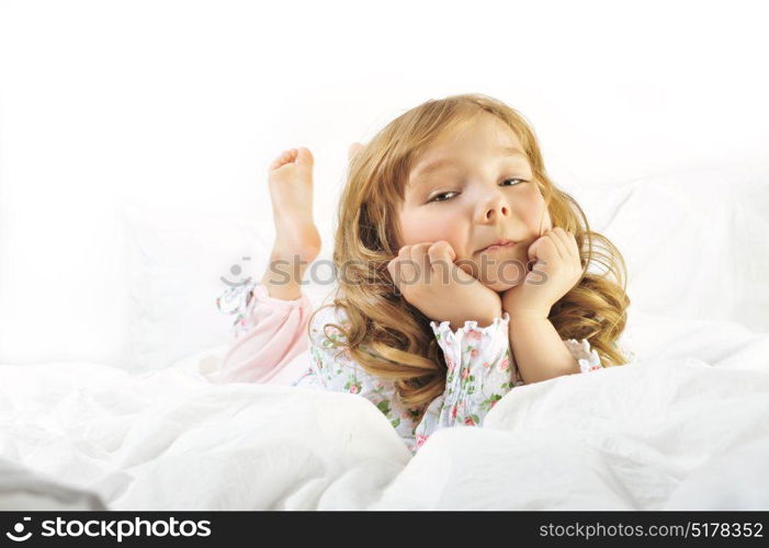 Cute little girl smiling on her with bed