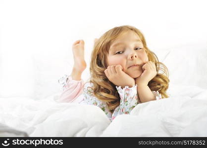 Cute little girl smiling on her with bed