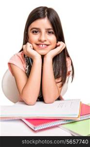 Cute little girl studying and smiling on desk