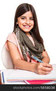 Cute little girl studying and smiling on desk