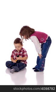 Cute little girl watching his brother with a drill