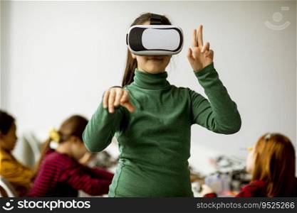 Cute little girl wearing VR virtual reality glasses in a robotics classroom